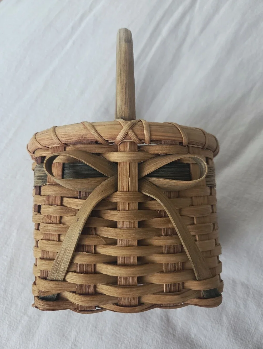 Vintage, Hand-Woven Basket Featuring A Unique Bow Detail And Green Accent